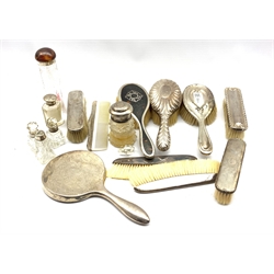 Various silver mounted dressing table items including hair and clothes brushes and combs, and a number of silver mounted glass dressing table bottles