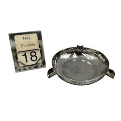 Hammered silver circular ashtray D10cm London 1945 Maker Robert Richard Prout and a perpetual calendar in silver frame with celluloid numbers (incomplete) with Carrs millenium mark 