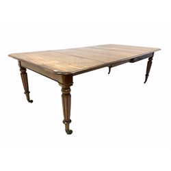 Mid 19th century mahogany extending dining table, the rectangular top with moulded edge and rounded corners, pull out with three additional leaves, raised on turned and reeded supports with brass cup castors 251cm/ 125cm x127cm, H77cm