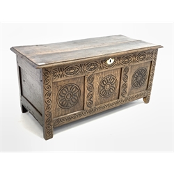 18th century and later three panel oak coffer, with floral carved roundels, raised on stile supports 