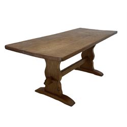'Gnomeman' oak dining table, the adzed three plank top, together with a later oak top over shaped end supports and sledge feet, united by an adzed stretcher, together with set of six (2+4) ladder back dining chairs with seats upholstered in leather  carved with gnome signature, by Thomas Whittaker of Littlebeck