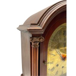 Gustav Becker - German 20th century 8-day mahogany cased mantle clock, three train Westminster chiming mantle clock  c1910,  break arch mahogany case with a round topped door flanked by reeded pilaster with Ionic capitals and raised on a stepped plinth, with a formerly silvered brass dial with engraved Roman numerals, minute track and steel fleur di Lis hands, engraved spandrels and subsidiary chime /silent dial, eight-day movement chiming the quarters and striking the hours on five gong rods. With pendulum and key. 