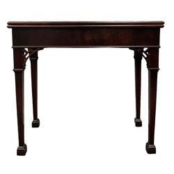 George III mahogany tea table, the fold over top over blank frieze raised on square tapering supports, terminating in spade feet