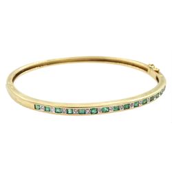 9ct gold channel set square cut emerald and diamond hinged bangle, import London 1992