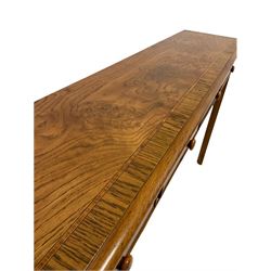 Figured oak hall table, the cross banded top with satinwood inlay over four frieze drawers, raised on square supports with pencil moulding and chamfered inner edge W 131cm, H77cm, D30cm