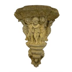 Classical design cast stone corbel, the relief body decorated with mischievous Putti flanked by eagles, the terminal decorated with an urn in the form of a Gorgoneion Medusa mask