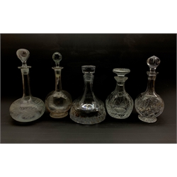 Five glass decanters comprising a heavy slice cut ships decanter, unmarked, Stuart mallet form decanter and three others (5)