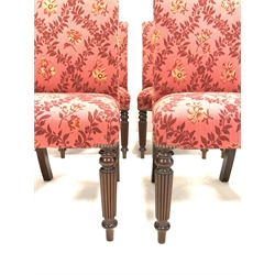 Set of eight 20th century mahogany high back dining chairs, upholstered in claret floral fabric, raised on turned reeded front supports, 