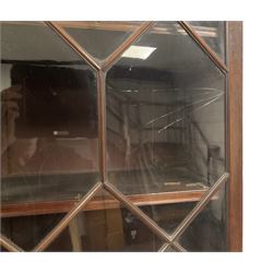 Early 20th century Georgian design mahogany bookcase on cupboard, dentil cornice over astragal glazed doors enclosing adjustable shelves, panelled cupboard base raised on bracket feet
