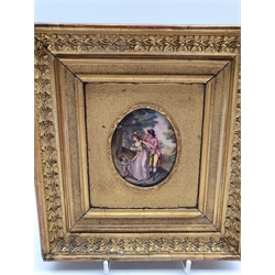Miniature enamelled oval plaque of depicting a Family walking in a woodland, H7.5cm in a gilt frame 