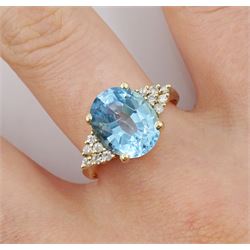 14ct gold oval topaz ring, each side set with six round brilliant cut diamonds, stamped 585