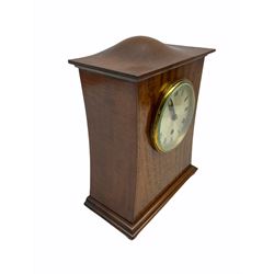 A twentieth century mahogany mantle clock with a waisted case in the art Nuovo style, contrasting satinwood stringing and  oval birds-eye maple inlay, rectangular stepped plinth raised on four wooden bun feet, top with an elongated sphere and ogee surround, Coventry eight-day Astral timepiece movement with a lever platform escapement and fast/slow regulation, movement number 14818, polished brass bezel with bevelled glass, silvered dial with roman numerals and minute track, with matching steel spade hands. 
With key.