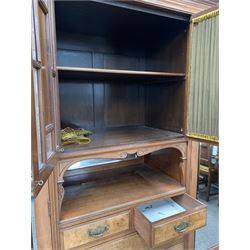 Late Victorian walnut wardrobe, broken arch pediment and dentil cornice over bevel glazed millinery cupboard with floral carved panels, bevelled mirror, open shelf and two short and three long drawers, flanked by two bevel glazed mirror doors, each enclosing interior fitted with shelf and for hanging, raised on a plinth base with recessed castors, W195cm, H212cm, D61cm