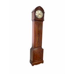 Late 19th century figured mahogany longcase clock with a lancet-shaped hood and stopped reeded pillars, trunk with a full-length wavy ogee topped door on a paneled rectangular plinth with applied and shaped skirting, 10” silvered circular convex dial with painted roman numerals and minute track, steel spade hands, convex glass with a cast brass bezel, dial  pinned directly to the eight-day rack striking movement, recoil anchor escapement striking the hours and half-hours on a coiled steel gong, with spoked pulleys, weights, key and pendulum.
This movement was possibly made by an engineer rather than a clockmaker and the case purposely made by a cabinet maker for the movement and dial.
