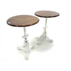 Pair of Victorian design cast iron tables, with circular mahogany tops raised on raised in column and intertwined fish leading to a leaf cast platform base and triple splay supports, D57cm
