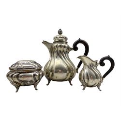 German silver three piece tea set of fluted baluster design, the tea pot with scroll lift and stained wood handles on shaped supports marked '800'   Maker Hermann Behrnd  43.8oz