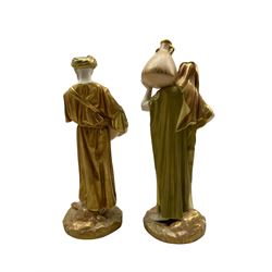 Pair of Royal Worcester porcelain figures modelled as male and female water carriers, dressed in green-gilt robes standing on a rocky ground, date marked 1913, shape 1250, H24.5cm 