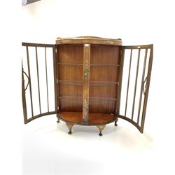 Early 20th century walnut bowfront display cabinet, with chinoiserie decoration, two glazed doors enclosing three glass shelves, raised on cabriole supports W89cm