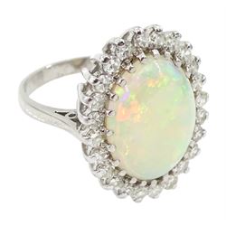 White gold oval opal and diamond cluster ring, stamped 18ct, total diamond weight approx 1.00 carat
