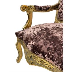 Pair late 20th century French style giltwood armchairs, the shaped back decorated with shell and flower heads, scrolled arm terminals, upholstered in buttoned purple crushed velvet, shaped apron carved with flower beads, cabriole supports 
