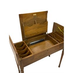 Edwardian oak metamorphic 'Britisher Writing Table', rectangular hinged top revealing correspondence compartments and hinged writing surface with pen rest and underside storage, flanked by twin hinged compartments with dividers, on turned supports