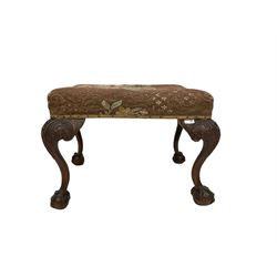 18th century stool, the upholstered cushion top, raised on mahogany carved ball and claw supports 
