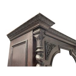 19th century oak gun cabinet, projecting leaf carved and moulded cornice, stepped shouldered arch glazed door flanked by two spiral turned pilasters, drawer with applied scrolling foliage carving over panelled cupboard, the door set with carved interlace foliate mount, moulded base