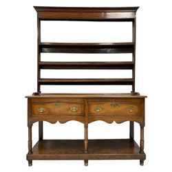 Georgian oak dresser, projecting cornice over plain frieze and three heights plate rack, the lower sections with rectangular top over two cockbeaded drawers and shaped aprons, turned supports joined by undertier, with shaped brass handle plates and escutcheons