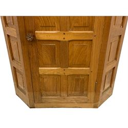 Beaverman - oak corner cupboard, moulded cornice over enclosed by panelled door and sides, the interior fitted with shelves, carved Yorkshire Rose handle and beaver signature, by Colin Almack, Sutton-under-Whitestone Cliffe, Thirsk