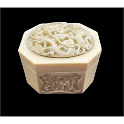 19th century Chinese ivory box and cover of rectangular form with canted corners, the cover carved with a Dragon amidst clouds, the sides carved with panels of peony and other flowers H6cm 
