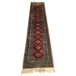 Persian Bokhara runner rug, with gul motif enclosed by repeating border 378cm x 84cm