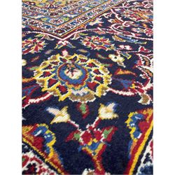 Persian design rug, with red field and navy boarder and floral decoration all over 