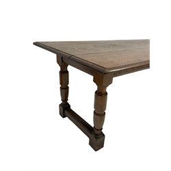 Oak dining table, the rectangular top raised on turned and block supports united by stretcher 