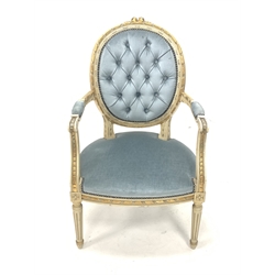 Louis XV style cream and gilt painted open armchair, the buttoned back rest over scrolled arm terminals and seat, raised on turned fluted supports, upholstered in blue velvet