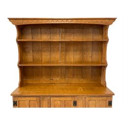 'Gnomeman' adzed oak dresser, raised two heights plate rack over rectangular top, three cupboards enclosed by panelled doors each above drawer, carved linen fold uprights, shaped end supports joined by shaped pegged stretcher, carved with gnome signature, by Thomas Whittaker of Littlebeck, W140cm, H184cm, D40cm