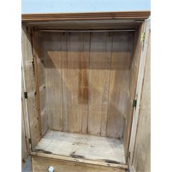 Victorian and later double pine wardrobe, the projecting cornice over two doors opening to reveal interior fitted for hanging over one long drawer, raised on a plinth base W125cm, H194cm, D55cm