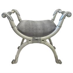 Regency design ivory and silver painted stool, the scrolled side rests moulded with silvered acanthus leaves, seat upholstered in a silver and black snake skin patterned fabric, raised on a curved X-frame base with paw feet