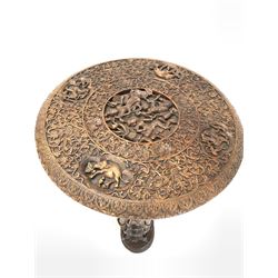 20th century Burmese carved hardwood occasional table, the circular top decorated with interlaced foliate, dragons, elephants, centred by stylised seated and reclining figures, raised on three figural uprights leading to trefoil base, D65cm, H61cm