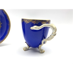 19th century Meissen cabinet cup and saucer, the cup painted in the manner of Wouwerman with a pastoral scene on blue ground, serpent moulded handle and paw feet, H9.5cm