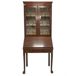 George III mahogany secretaire bookcase, projecting cornice with banded frieze, the two adjustable shelves enclosed by astragal glazed doors, the fall-front concealing fitted interior with central cupboard flanked by six pigeonholes over three drawers, single stay drawer to base with lion mask handles with ring drops, raised on tapering supports with carved lappet, terminating in ball and claw feet
