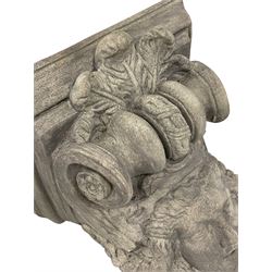 Composite corbel, the central mask in the form of the Gorgon Medusa with extending garland braids, the crown surmounted by a scroll bracket with acanthus leaf pediment, the cartouche apron set with a central rosette