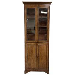 19th century mahogany bookcase on cupboard, the projecting cornice over two glazed doors and two cupboard doors, raised on bracket supports 