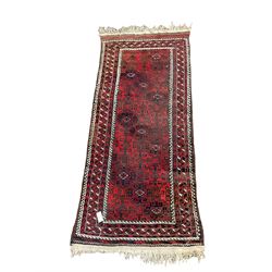 Persian rug, the red and field with geometric design surrounded by a red border 210cm x 90cm
