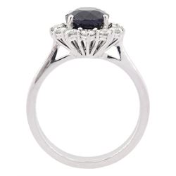 18ct white gold oval cut sapphire and round brilliant cut diamond cluster ring, hallmarked, sapphire approx 2.60 carat, total diamond weight approx 0.55 carat