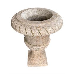 Polished granite Campana shaped garden urn on base, cavetto edge over carved egg and dart decoration