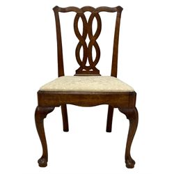 Set four George III mahogany dining chairs, shaped cresting rail over interlaced splats, the drop in seats upholstered in later patterned ivory fabric, moulded seat rails with shaped apron, raised on cabriole front supports terminating to pad feet