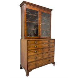 George III mahogany secretaire bookcase, fitted with  astragal glazed doors enclosing three  adjustable shelves over four correspondence drawers, fall-front enclosing fitted serpentine interior with pigeonholes and drawers with bone handles, flanking central cupboard with inlaid heraldic shield inscribed 'Dum Spiro Spero', above three graduating drawers, raised on ogee feet
