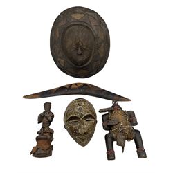 African carved wood shield, African wood mask, two African figures and an Aboriginal boomerang with decoration