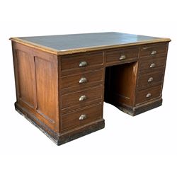 Late Victorian scumbled pine knee hole desk, the rectangular mahogany top with inset skiver and moulded edge over nine short graduated drawers, raised on a plinth base 138cm x 84cm, H75cm