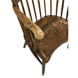 Early 19th century primitive elm and beech Windsor chair, high hoop and stick back over shaped dished saddle seat, raised on cylindrical supports united by swell turned H-stretchers